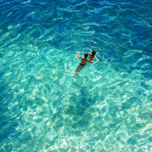 Two Swimmers in Sunlit Turquoise Water Wall Art artwork view | OILDECO