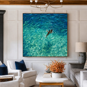 Two Swimmers in Sunlit Turquoise Water Wall Art styled interior scene 2 | OILDECO