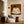 Quiet Cross-Legged Figure in Cream on Burnt Ochre Wall Art styled interior scene 2 | OILDECO