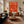 Sunlit Tennis Rally on an Orange Court Wall Art styled interior scene 1 | OILDECO